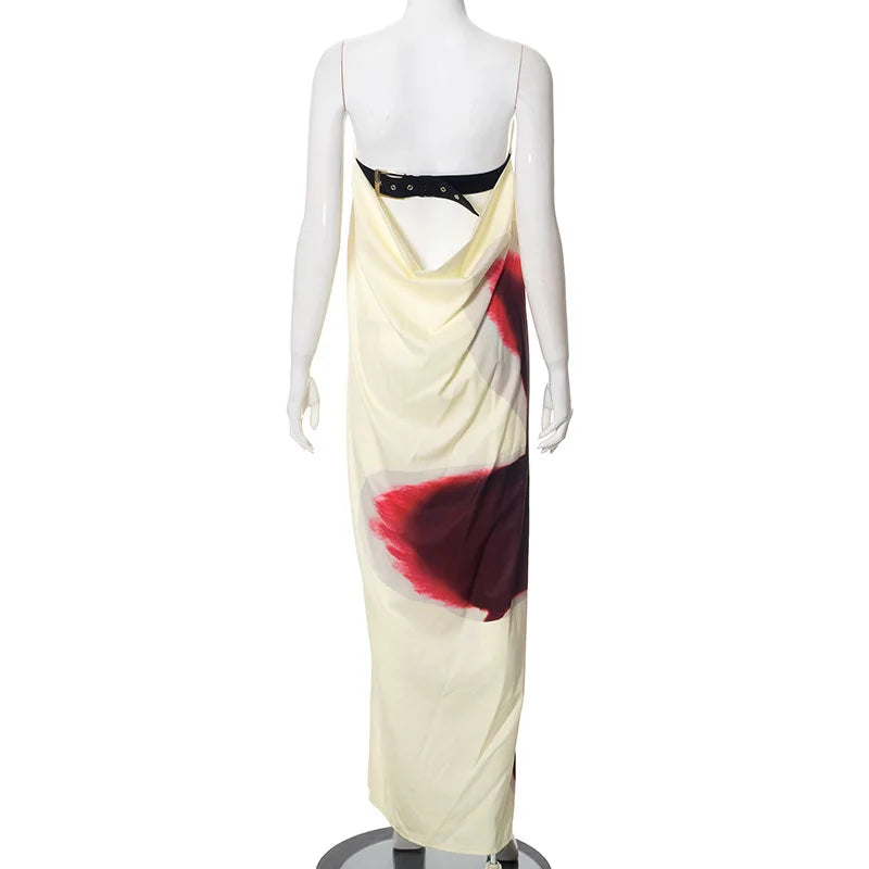 Mannequin wearing a cream dress with red and black abstract design on a white background