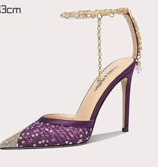Purple high-heeled shoe with gold accents on a white background