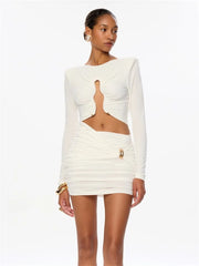 Woman wearing a white long-sleeve dress with cut-out design on a white background