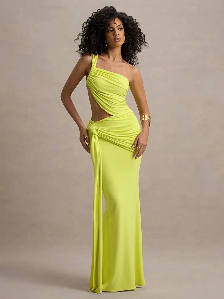 Woman wearing a bright yellow one-shoulder gown against a neutral background