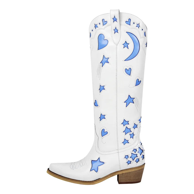 White knee-high boot with blue star and moon embroidery, featuring a pointed toe and block heel.
