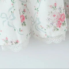 Floral-patterned fabric with lace trim on a white background