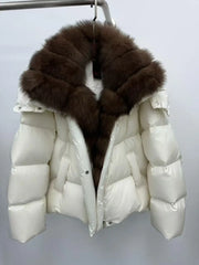 White puffer jacket with a large brown fur hood on a gray background