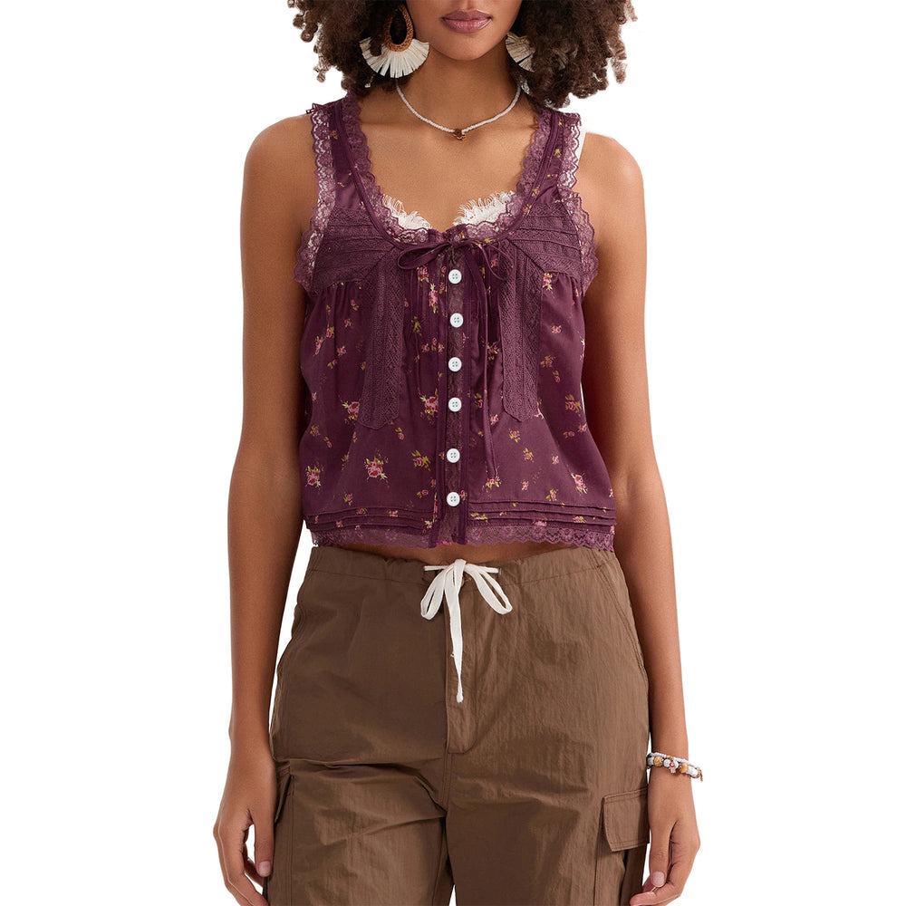 Woman wearing a purple sleeveless top with lace details and brown pants on a white background