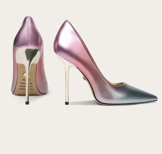 Pair of high-heeled shoes on a light background