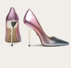 Pair of high-heeled shoes on a light background