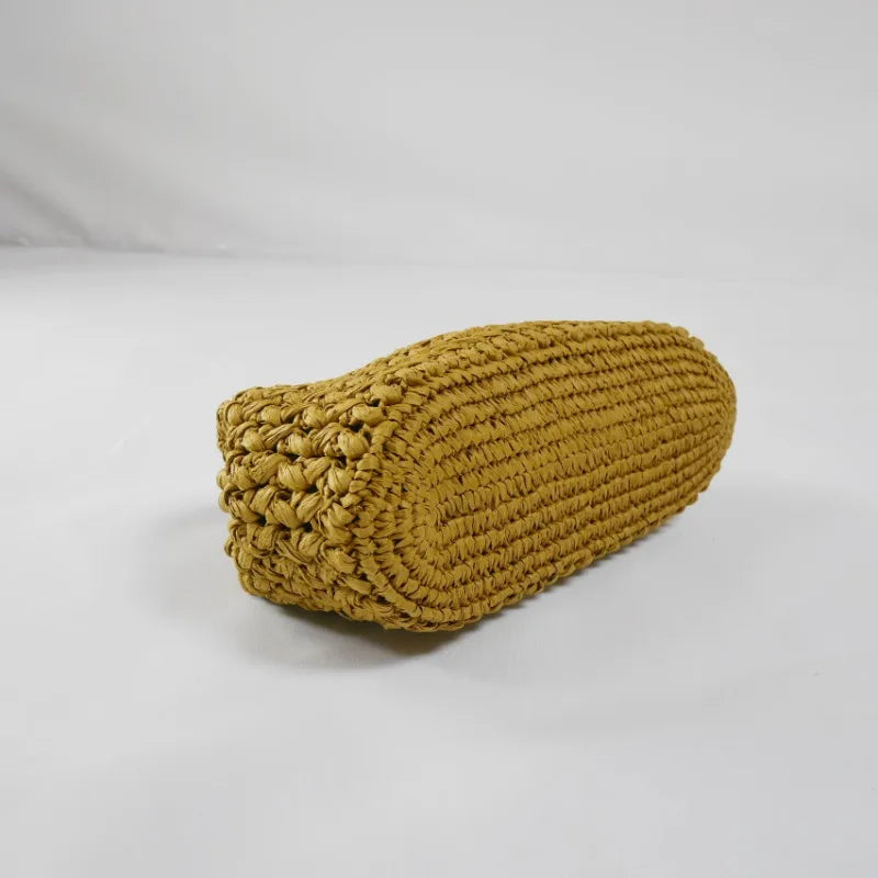 Mustard yellow crocheted cylindrical pillow on a white background