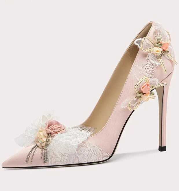 High-heeled shoe with floral design on a light gray background