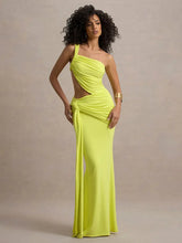 Woman wearing a bright yellow one-shoulder gown against a neutral background
