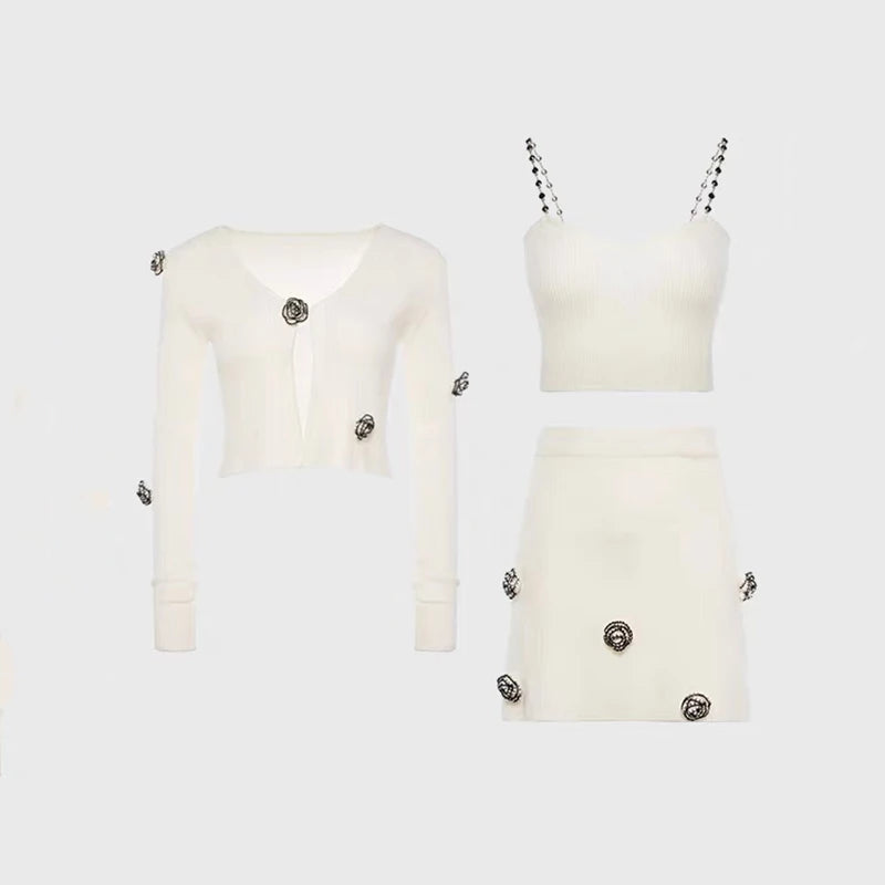 White outfit with embellishments on a light gray background