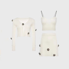 White outfit with embellishments on a light gray background