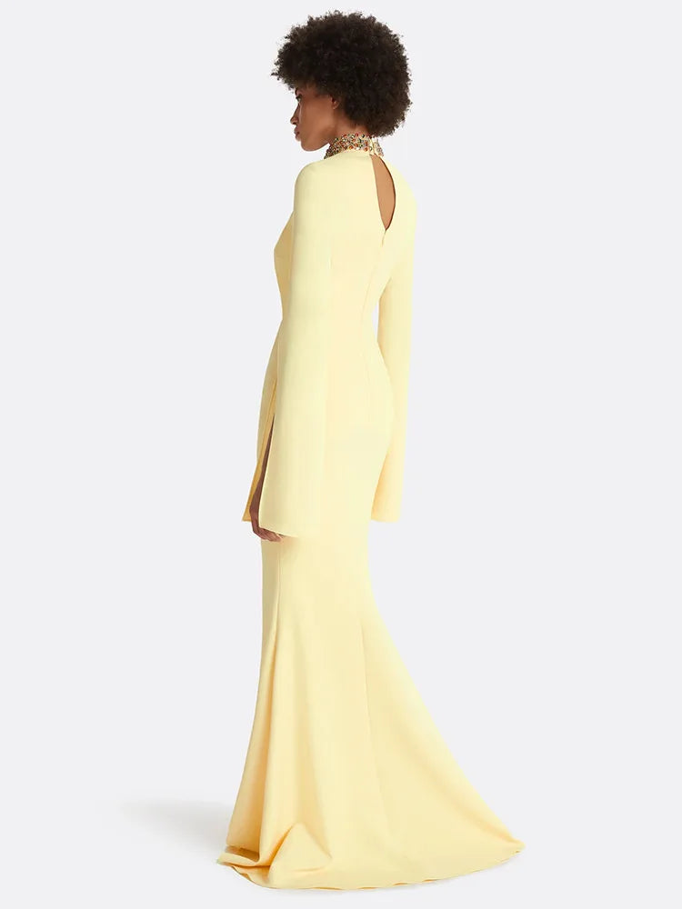 Side view of yellow maxi dress with cape sleeves and beaded neckline