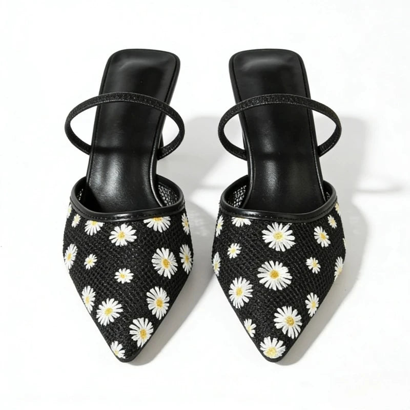 Close-up of black daisy embroidered mesh slingback heels