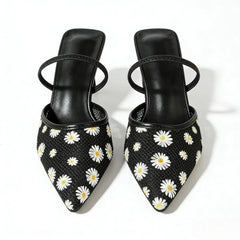 Close-up of black daisy embroidered mesh slingback heels