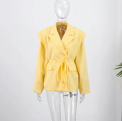 Yellow blazer on a mannequin against a white background