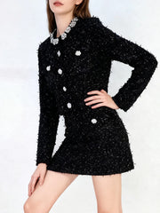 Black textured dress with white accents on a white background