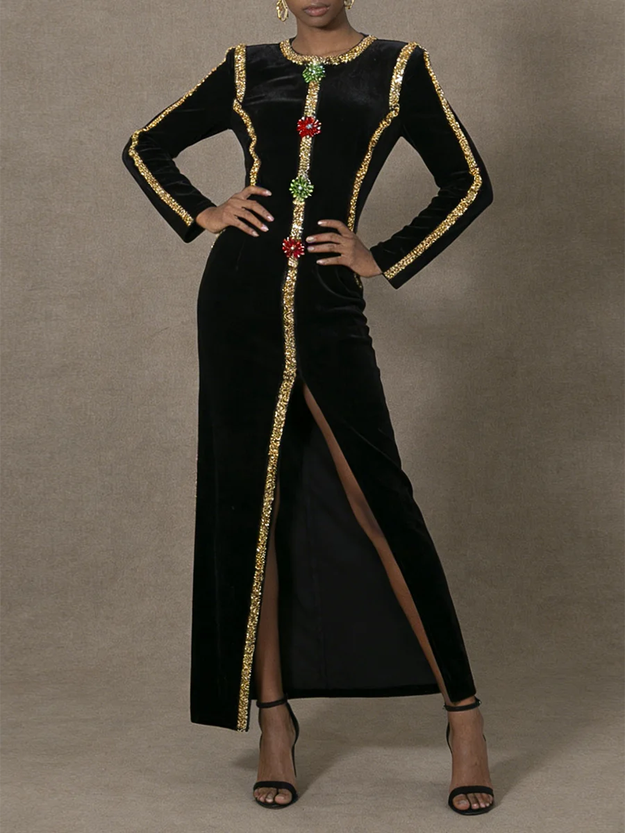 Black dress with gold and red embellishments on a gray background