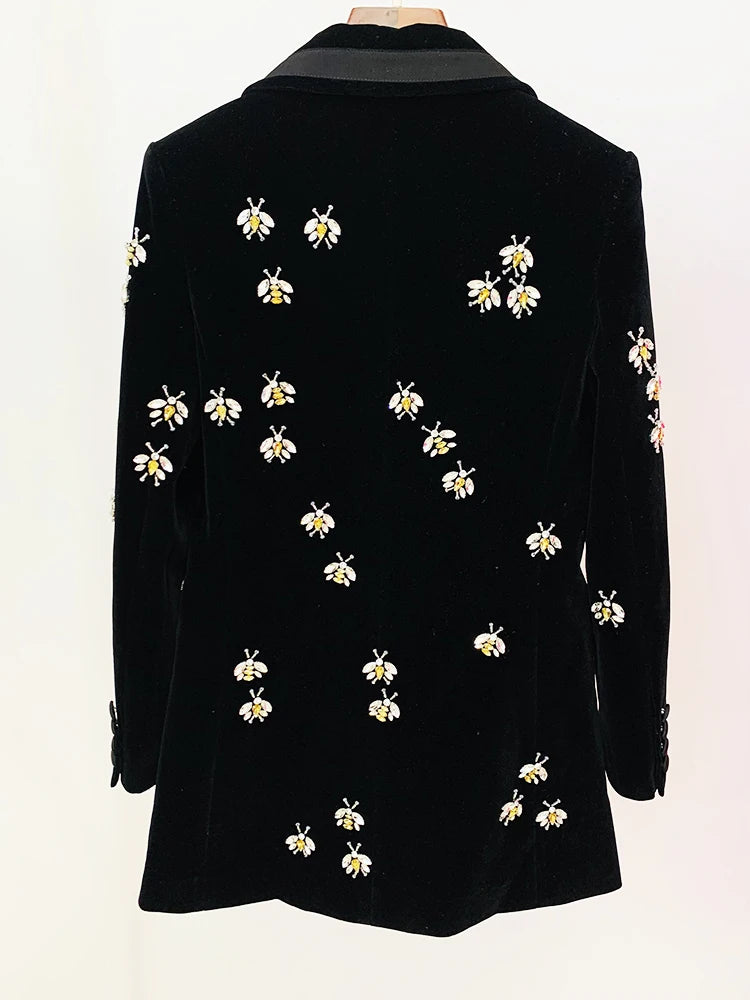 Rear view of a black velvet blazer with beaded bee embellishments.