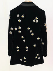 Rear view of a black velvet blazer with beaded bee embellishments.