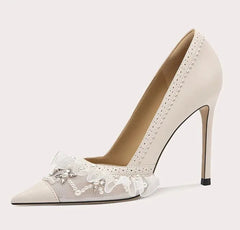 High-heeled shoe with lace details on a light gray background