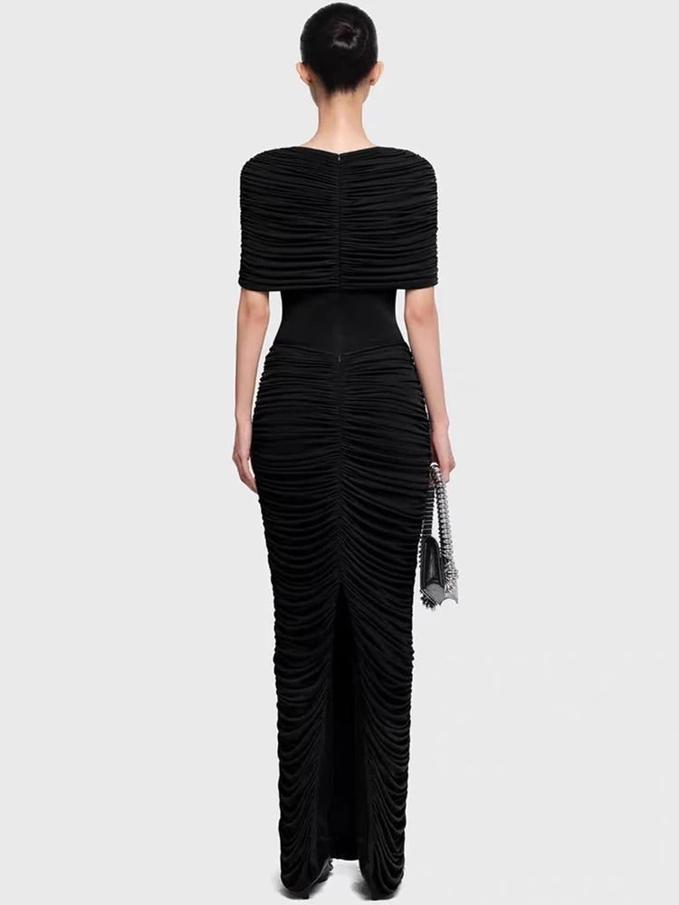 Black evening gown with ruched design on a white background