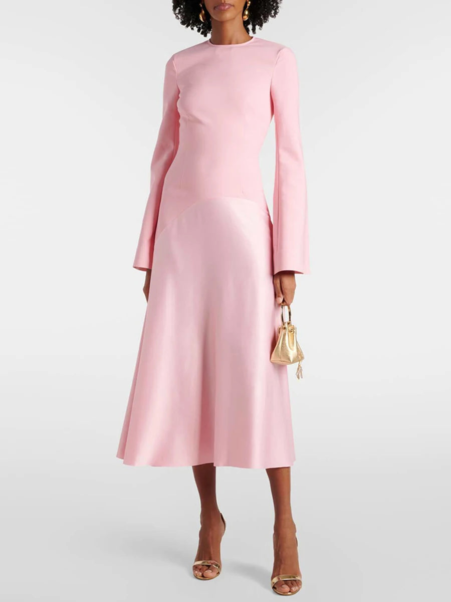 Pink long-sleeve O-neck midi dress showing the fitted bodice and flared skirt shape on model