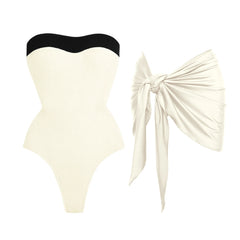 Textured cream swimsuit with black trim and cream sarong.