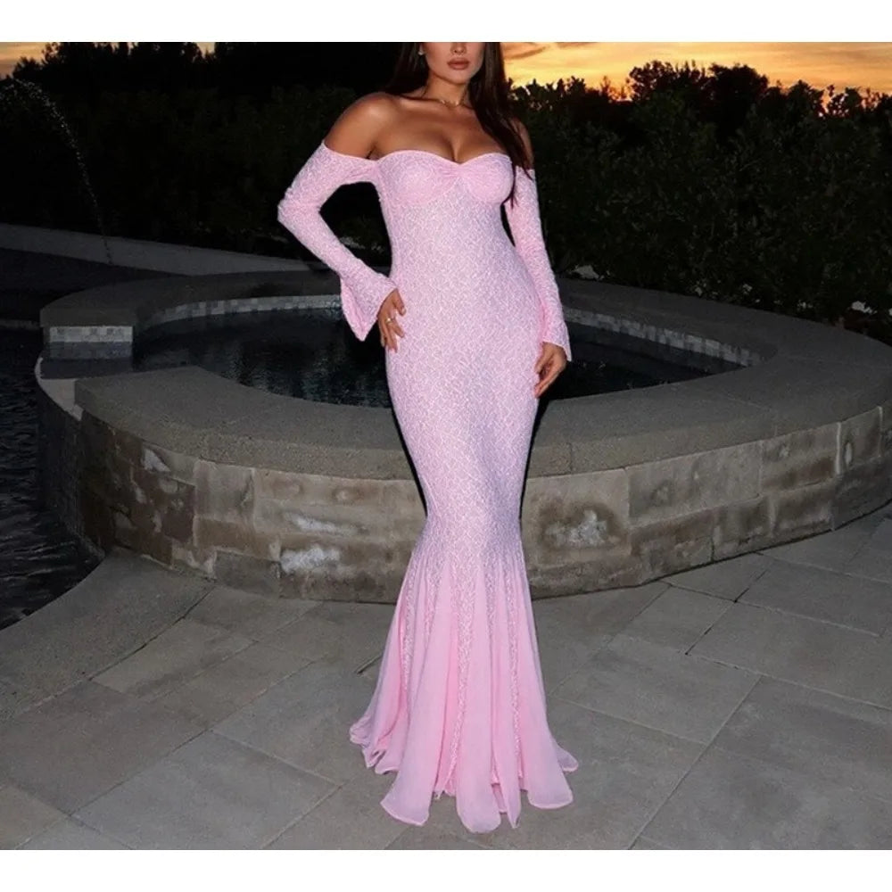 Pink off-shoulder evening gown worn by a person standing outdoors.