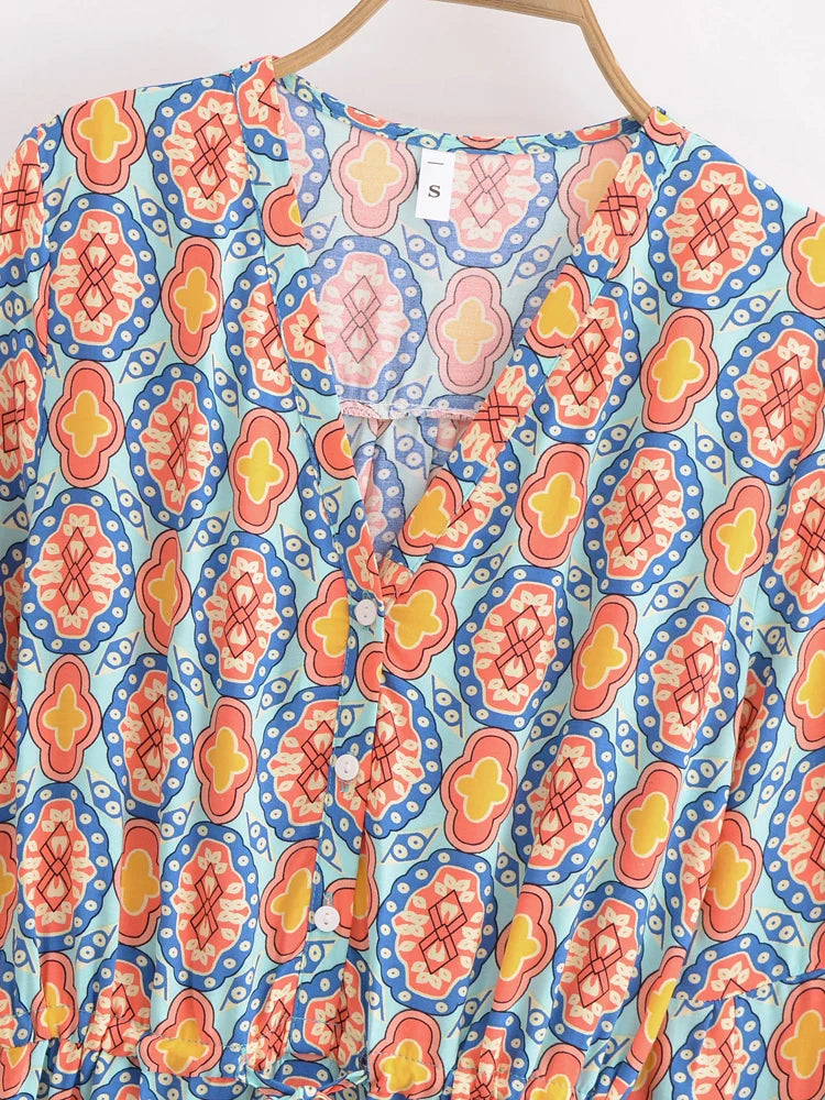 Detail of the V-neckline and buttons on the mini dress