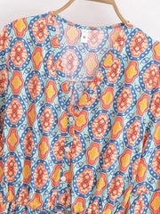 Detail of the V-neckline and buttons on the mini dress