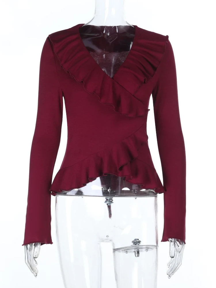 Red ruffled top on a mannequin against a white background
