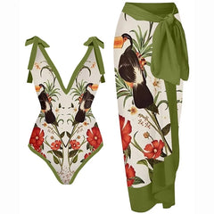 V-neck one-piece swimsuit with toucan print and tie straps, paired with a matching green sarong.