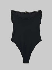 Black swimsuit with ruffled straps on a gray background