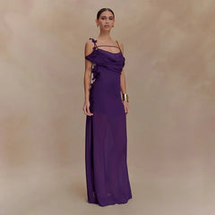 Woman wearing a purple evening gown against a beige background