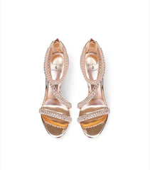 Rose gold high-heeled shoes with crystal embellishments on a white background
