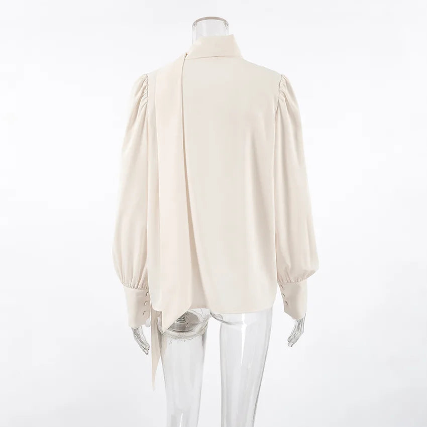 Beige blouse on a mannequin against a white background