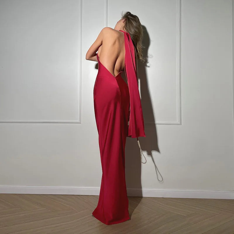 Woman wearing a red dress with a white wall background