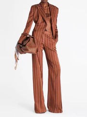Double breasted striped blazer and wide leg pants suit with handbag on model