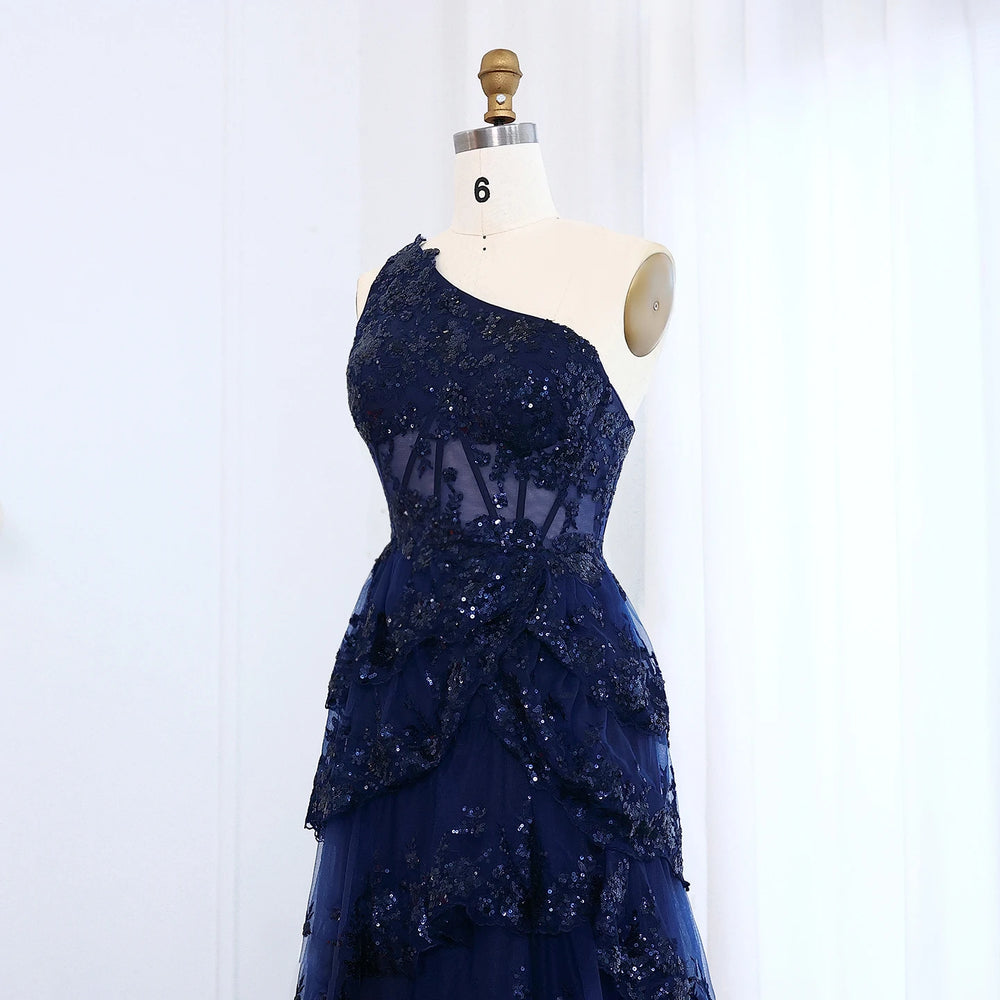 Navy blue sequin dress on a mannequin against a white background