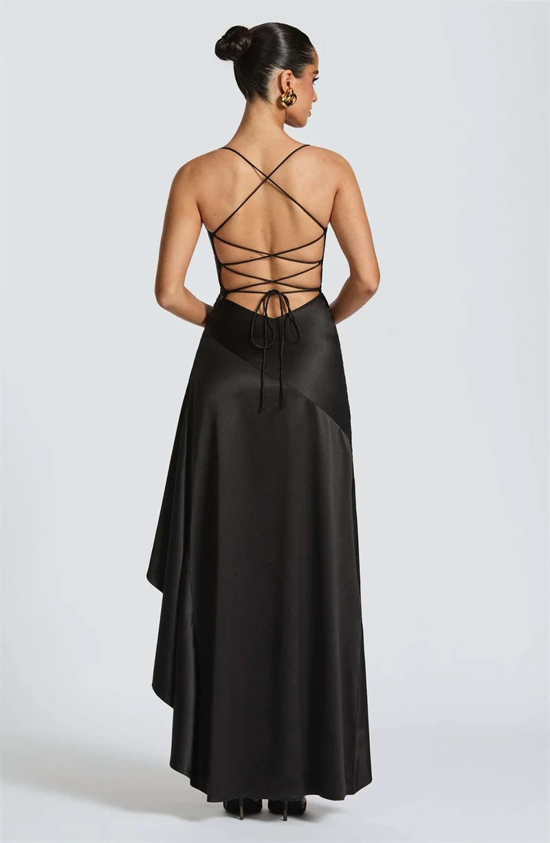 Black evening gown with intricate back design on a white background