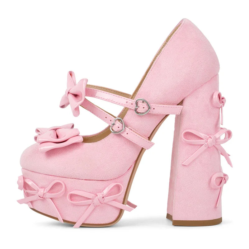 Pink platform Mary Jane heels with bow embellishments and chunky block heel.