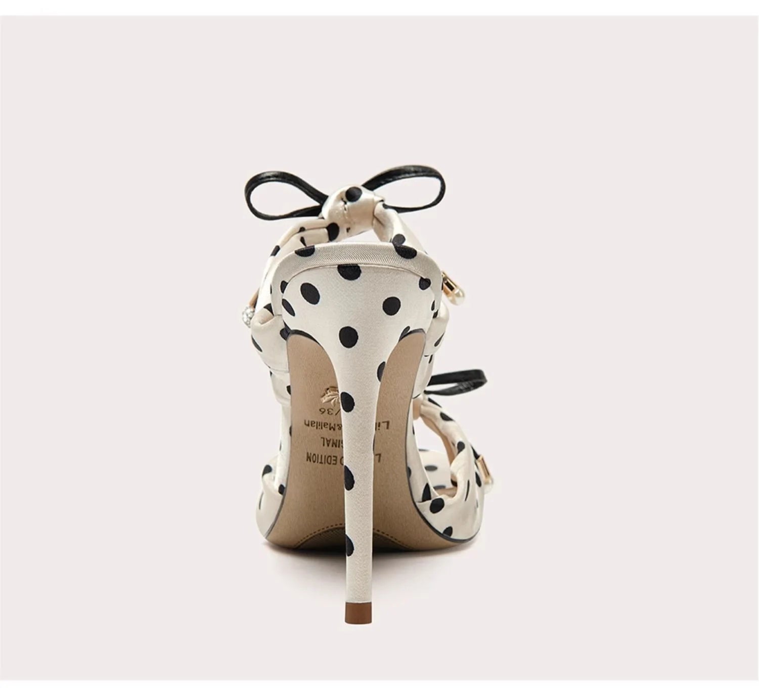 Polka dot high-heeled shoes on a white background
