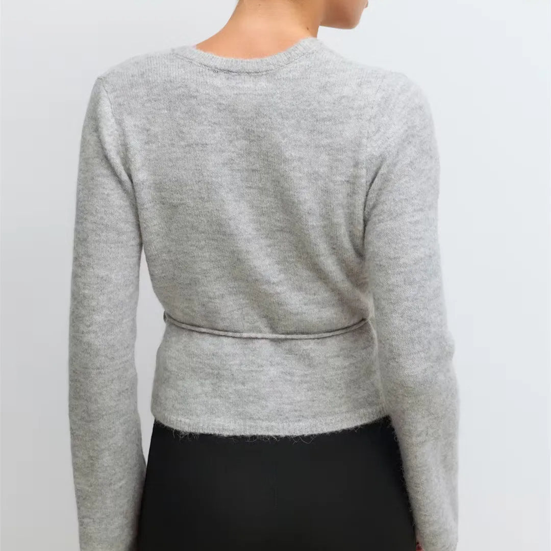 Gray sweater worn by a person on a light gray background