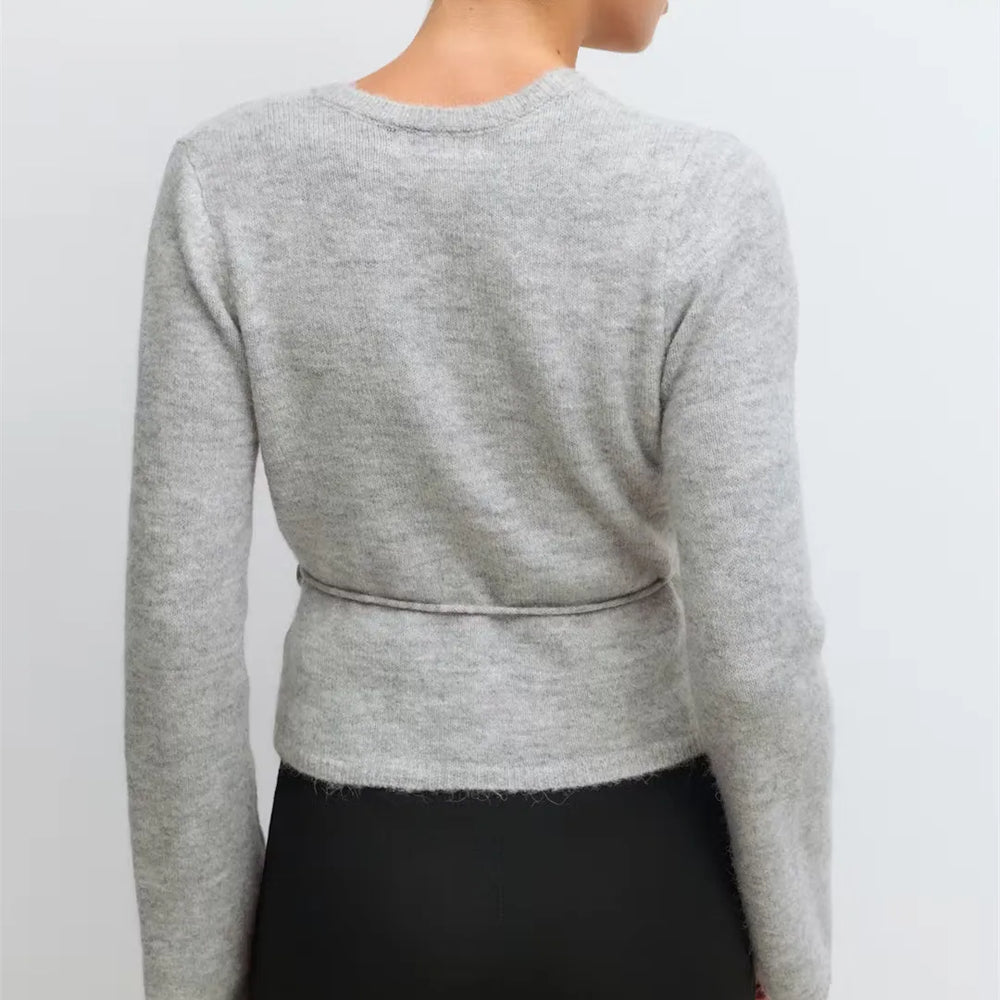Gray sweater worn by a person on a light gray background