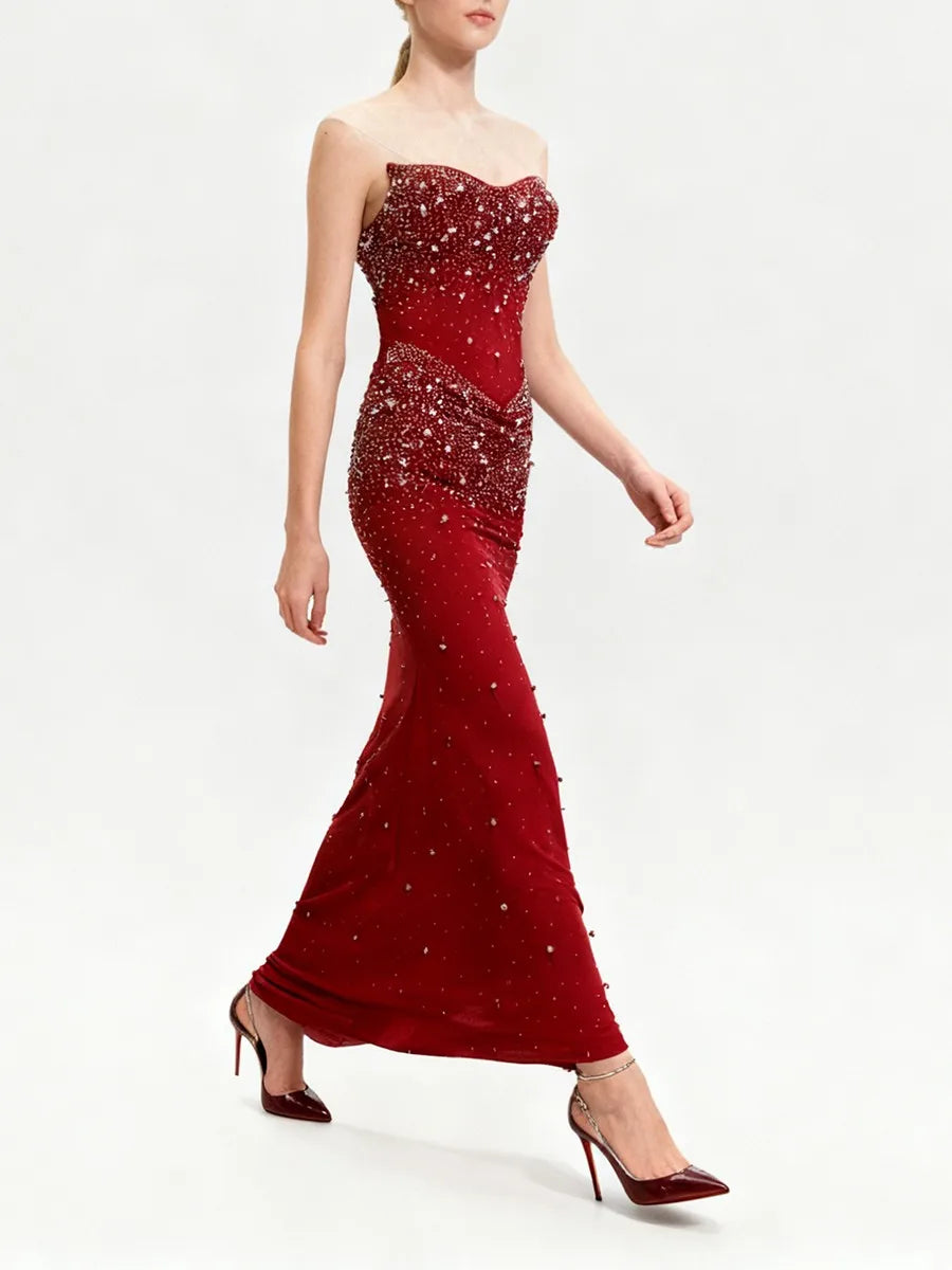 Red strapless evening gown with sequin details on a white background