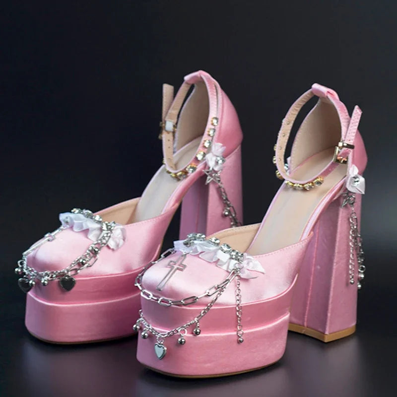 Pink high-heeled shoes with decorative elements on a dark background