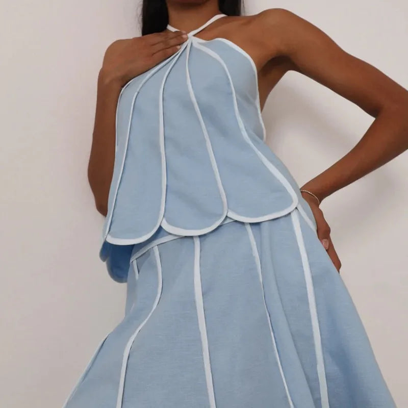 Model wearing petal trim halter crop top and flare mini skirt set