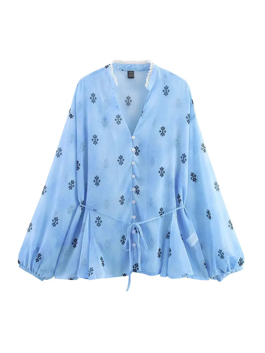 Light blue blouse with floral patterns