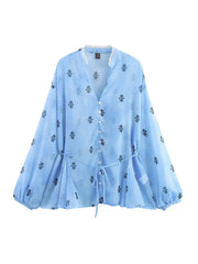 Light blue blouse with floral patterns