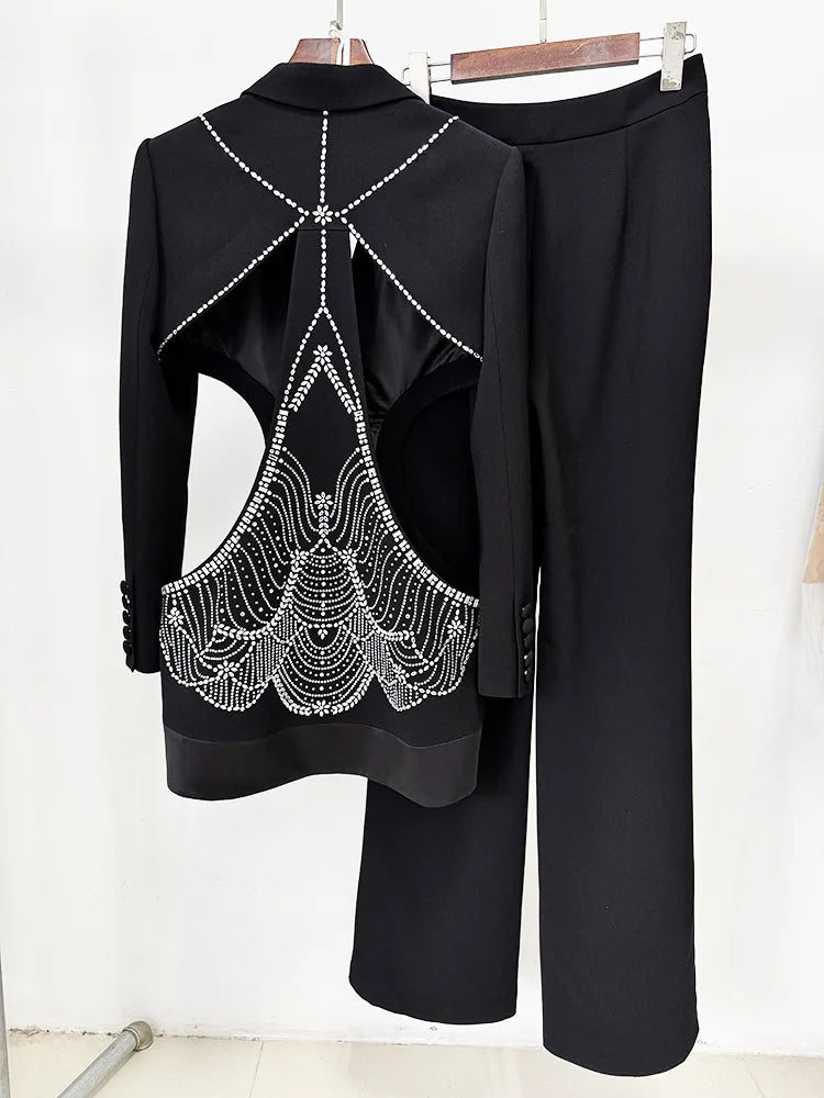 Black outfit with decorative back design on a white background